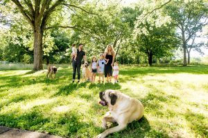 A photo of Danny Gokey, his family and his dogs in a lush field | Celebrity Dogs and Their People by Sara Kauss